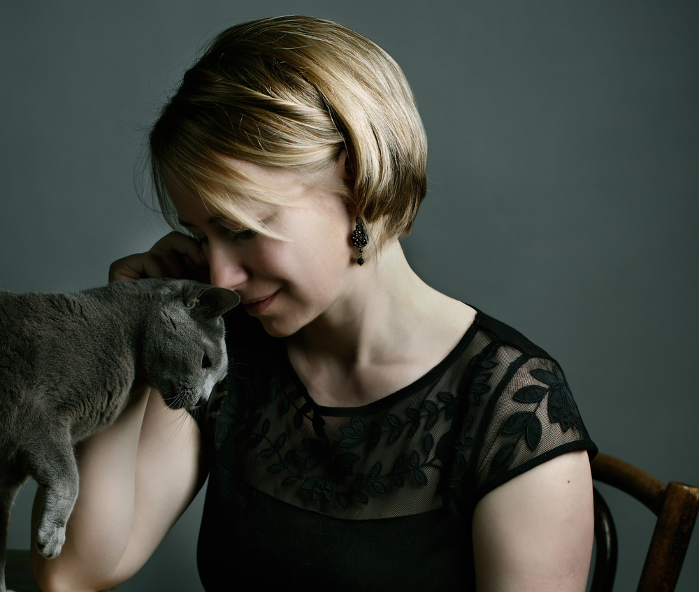 Portrait of an adult Woman with her purebred Russian Blue Cat