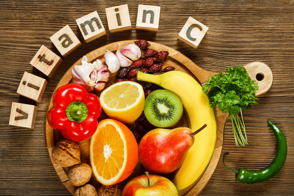 Vitamin C in fruits and vegetables. Natural products rich in vitamin C as oranges, lemons, dried fruits rose, red pepper, kiwi, parsley leaves, garlic, bananas, pears, apples, walnuts, chili.