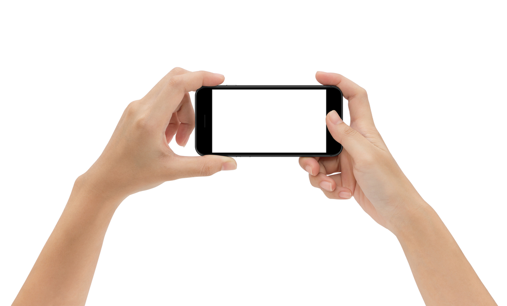 hand holding phone isolated on white background, mock-up smartphone matte black color