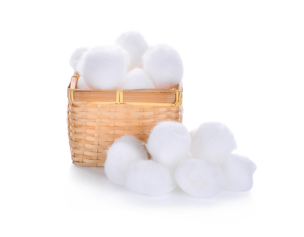 cotton wool in wooden basket isolated on a white background