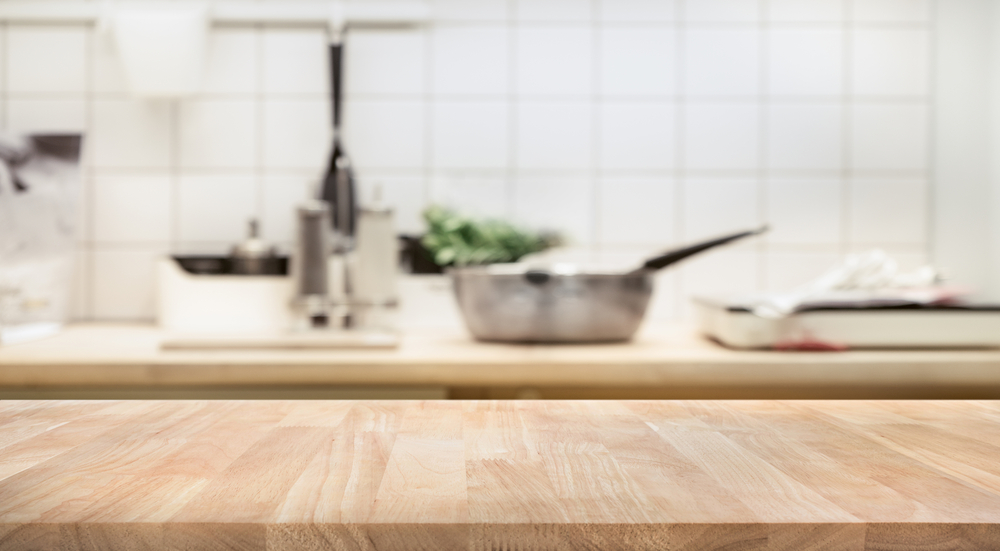 Wood table top on blur kitchen room background .For montage product display or design key visual layout.